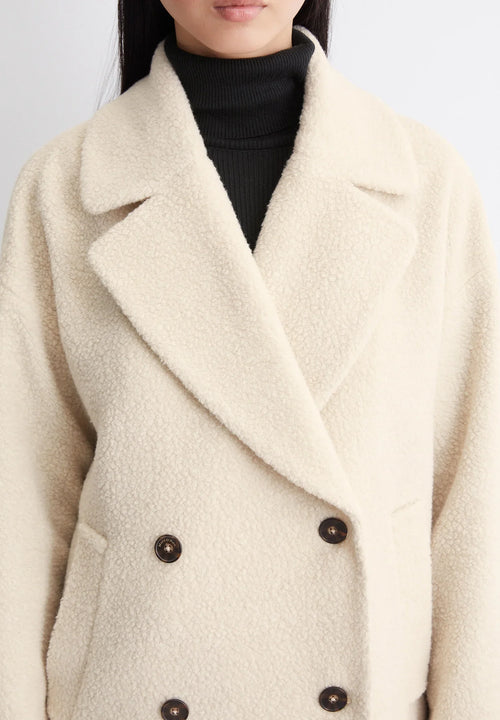 Model wearing double-breasted longline coat in Ivory Cream – ELEGENZE